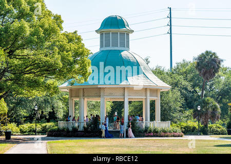 Charleston, USA - May 12, 2018: City in South Carolina with people wedding prom ceremony party students dressed in Hampton Park Gazebo