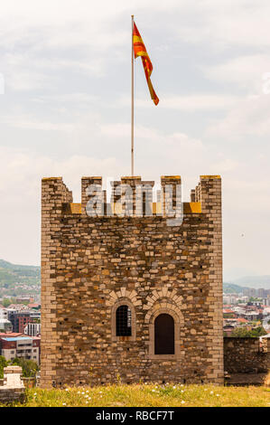 Skopje, Macedonia - June 10, 2013: Ancient masonry stone tower with Macedonian flag on the roof as a part of ancient fortress Stock Photo