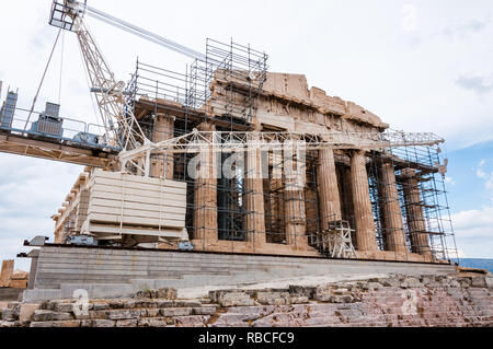 Athens, Greece - June 12, 2013: The famous Parthenon on Acropolis hill under reconstruction surrounded by scaffolding and standing big construction cr Stock Photo