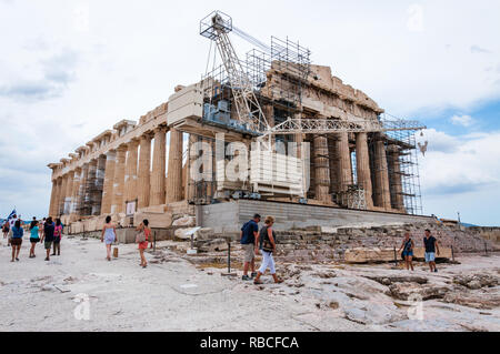 Athens, Greece - June 12, 2013: The famous Parthenon on Acropolis hill under reconstruction surrounded by scaffolding and standing construction crane  Stock Photo