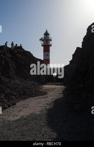 CAPE TENO, TENERIFE, CANARY ISLANDS, SPAIN - JULY 23, 2018: Lighthouse on the rocky shore of the Atlantic Ocean. Cape Teno (Punta de Teno). Tenerife.  Stock Photo