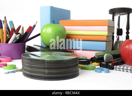 stack of CDs and school supplies isolated on white background.photo with copy space Stock Photo