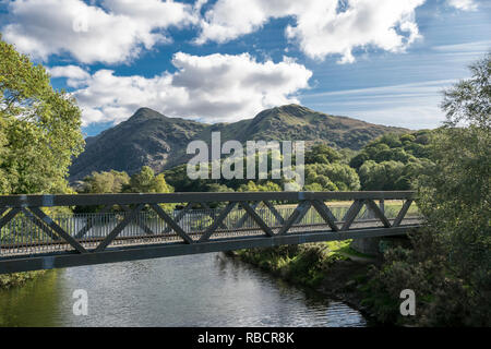 Llyn Padarn Country Park joining river for the two lakes at Llanberis in North Wales view towards Snowdon Yr Wyddfa mountain Stock Photo