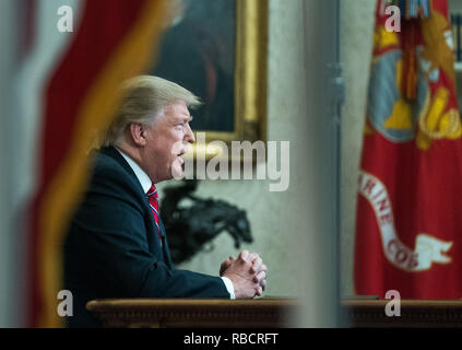 Washington, United States Of America. 08th Jan, 2019. President Donald Trump is seen through the window of the Oval Office as he delivers a primetime address on the government shutdown and his funding request for over $5 billion for a southern border wall, at the White House in Washington, DC Credit: Kevin Dietsch/Pool via CNP | usage worldwide Credit: dpa/Alamy Live News Stock Photo