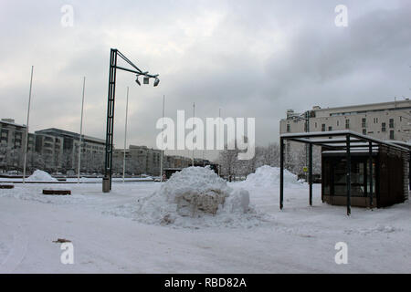 Square of Ruoholahti was covered suddenly with snow, when winter appears to Helsinki, the capital of Finland Stock Photo