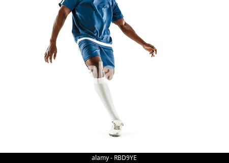 The legs of soccer player close-up isolated on white. African american model in action or movement with ball. The football, game, sport, player, athlete, competition concept Stock Photo