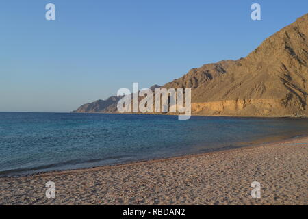 A wonderful view of the mountains with the sea with the sands of the beach , clear sky after noon in Dahab, red sea , Egypt , middle east Stock Photo