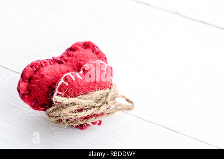 Two decorative hearts on wooden background. Symbol of love. Stock Photo