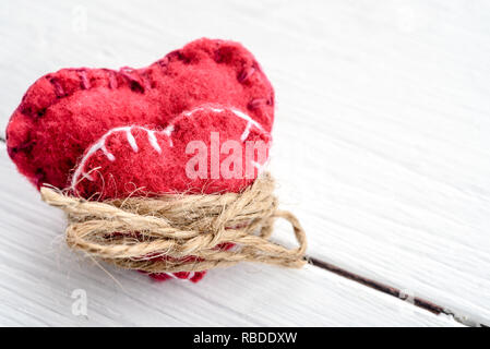 Two decorative hearts on wooden background. Symbol of love. Stock Photo