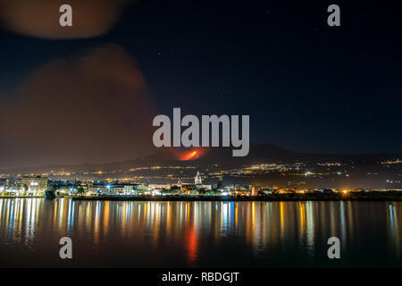 An impressive volcanic eruption and ash plume generated by volcano Mt. Etna, december 2018, Catania, Sicily,  Italy Stock Photo