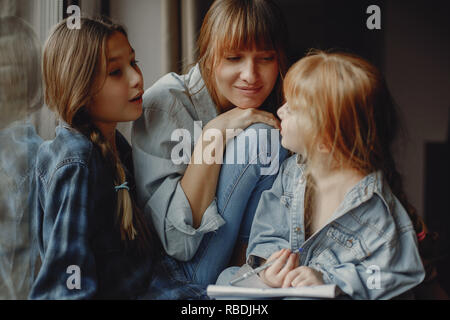 Mother with daughters at home Stock Photo