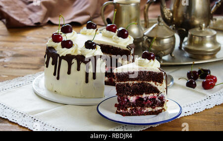 Black forest cake, Schwarzwalder Kirschtorte, Schwarzwald pie, dark chocolate and cherry dessert on wooden background Stock Photo