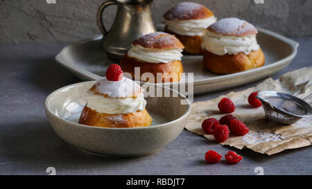Semla or semlor, vastlakukkel, laskiaispulla is a traditional sweet roll made in various forms in Sweden, Finland, Estonia, Norway, Denmark, especially Shrove Monday and Shrove Tuesday Stock Photo
