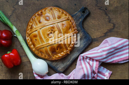 Empanada de atun, Traditional pie stuffed with tuna fish typical from Galicia, Spain, top view, wooden background Stock Photo