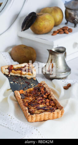 caramel apple tart on the white wooden buffet, grey rennet apples Stock Photo