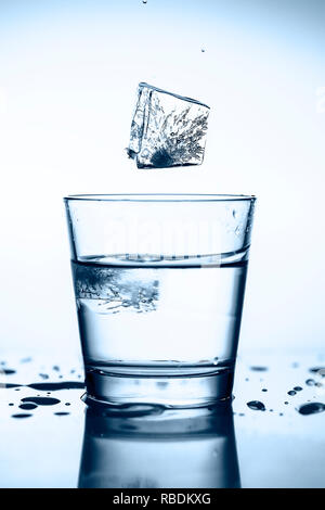 Splash ice cubes in a water glass Stock Photo
