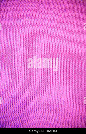 Purple  fuchsia magenta  Knitted pattern wool sweater texture close up. Handmade purple knitting wool texture background Stock Photo