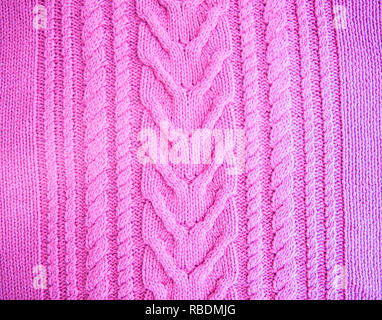 Purple  fuchsia magenta  Knitted pattern wool sweater texture close up. Handmade purple knitting wool texture background Stock Photo