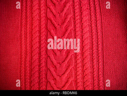 Red Knitted pattern wool sweater texture close up. Handmade red knitting wool texture background Stock Photo