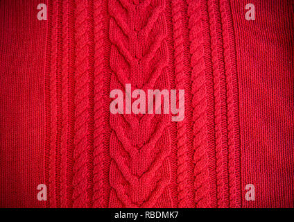 Red Knitted pattern wool sweater texture close up. Handmade red knitting wool texture background Stock Photo