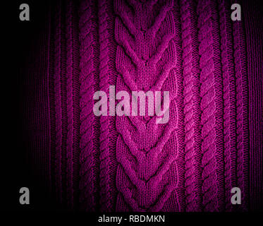 Purple  fuchsia magenta  Knitted pattern wool sweater texture close up. Handmade purple knitting wool texture background Stock Photo