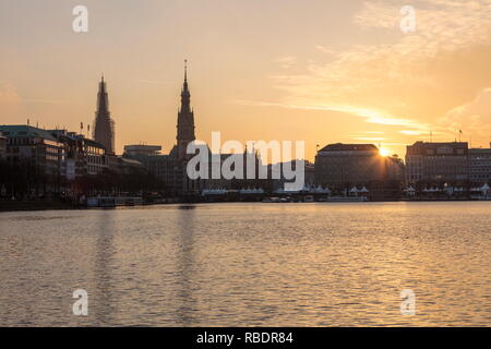 The artificial Inner Alster Lake frames the old buildings and palace of the city center at sunset Hamburg Germany Euope