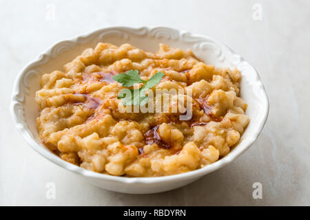 Keskek Traditional Food made with Wheat, Meat and Fried Butter Sauce. Traditional Organic Food. Stock Photo