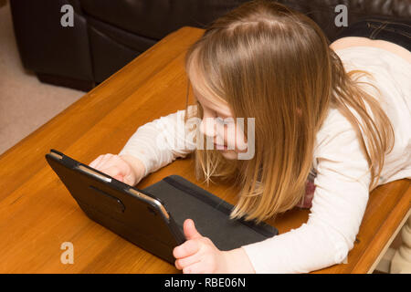 young girl playing with a tablet, digital device, iPad, screen, Three years old child Stock Photo