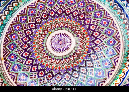 Pottery of colorful hand painted ceramic bowls and plates Stock Photo