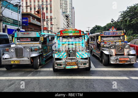 Manila, Philippines-October 24, 2016: Colorist dyipnis-jeepneys are a common means of public transportation all across the country-here stopped at a t Stock Photo