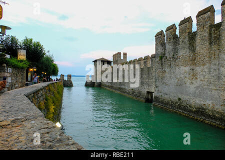 Sirmione, Italy - August 09, 2018: People are walking on colorful streets of Sirmione Italian town on Garda Lake. Italy Stock Photo