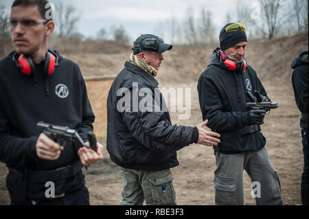 Pozarevac, Serbia - December 21-24, 2018: Instructor Zeljko Vujicic teaches large group of students on the shooting range GROM, how to safely use gun 