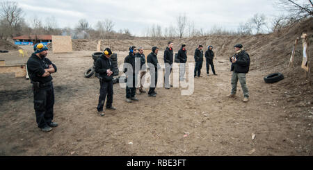 Pozarevac, Serbia - December 21-24, 2018: Instructor Zeljko Vujicic teaches large group of students on the shooting range GROM, how to safely use gun 