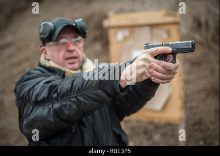 Pozarevac, Serbia - December 21-24, 2018: Instructor Zeljko Vujicic teaches his students on the shooting range GROM, how to safely use the gun on KAPA
