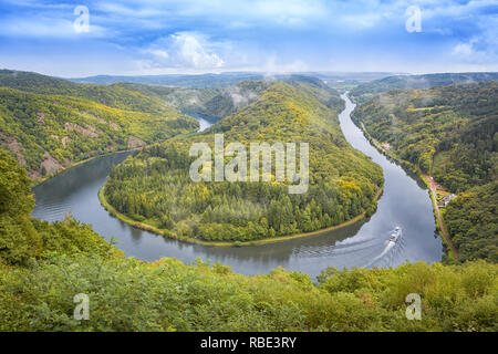 Saar loop near Cloef and Mettlach, Germany. A passenger ship with tourists to bottom right. Stock Photo