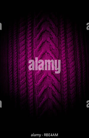 Purple  fuchsia magenta  Knitted pattern wool sweater texture close up. Handmade purple knitting wool texture background Stock Photo
