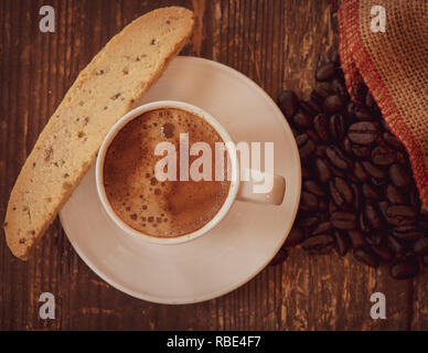 Afternoon espresso and biscotti on weathered wood. Stock Photo