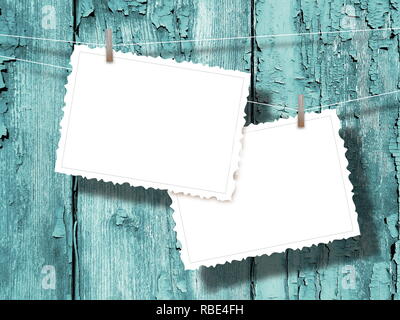 Two blank postcard frames against aqua weathered wooden background Stock Photo