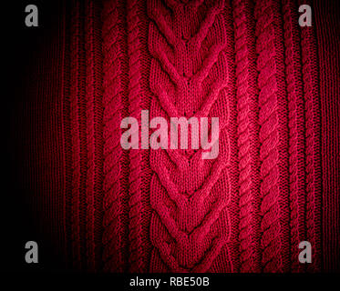 Red Knitted pattern wool sweater texture close up. Handmade red knitting wool texture background Stock Photo