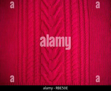 Red Knitted pattern wool sweater texture close up. Handmade red knitting wool texture background Stock Photo