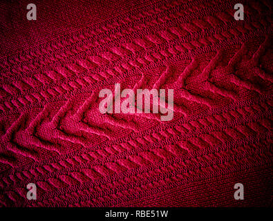 Red Knitted pattern wool sweater texture close up. Handmade red knitting wool texture background Stock Photo