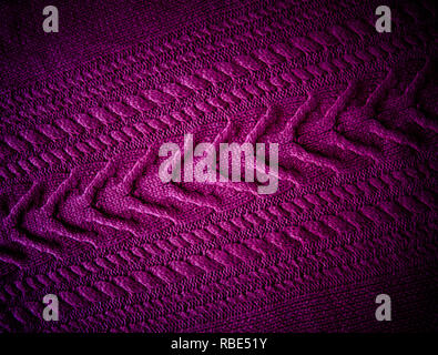 Purple  fuchsia magenta  Knitted pattern wool sweater texture close up. Handmade purple knitting wool texture background Stock Photo