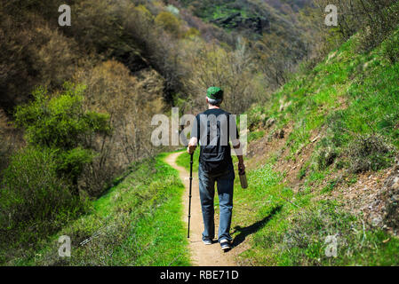 Senior Man hiking on a sunny day, outdoors healthy lifestyle abstract