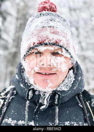 Close up portrait of man with frozen snowy face and hat Stock Photo