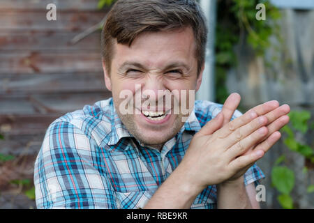 Cunning tricky mature man thinking looking with hand together. Concept of unfair game Stock Photo