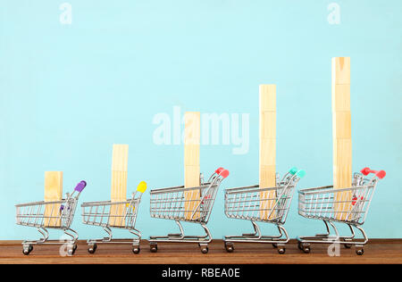 Five shopping carts on a blue background, showing a successful commercial experience Stock Photo