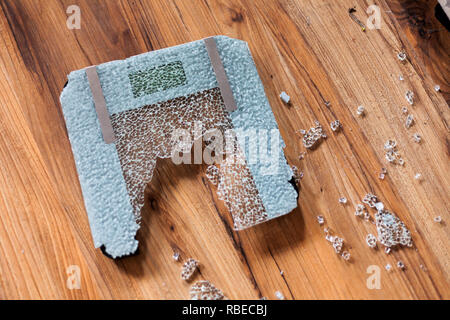 Broken digital human scale on the floor. Broken glassy digital scale for measuring people Stock Photo