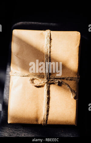 wrapped gift with shadows in twine Stock Photo