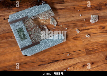 Broken digital human scale on the floor. Broken glassy digital scale for measuring people Stock Photo