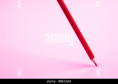 red pencil Floating on red background Stock Photo